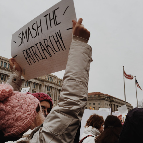 A woman at the DC Women's March holding a sign with the words "Smash the Patriarchy"