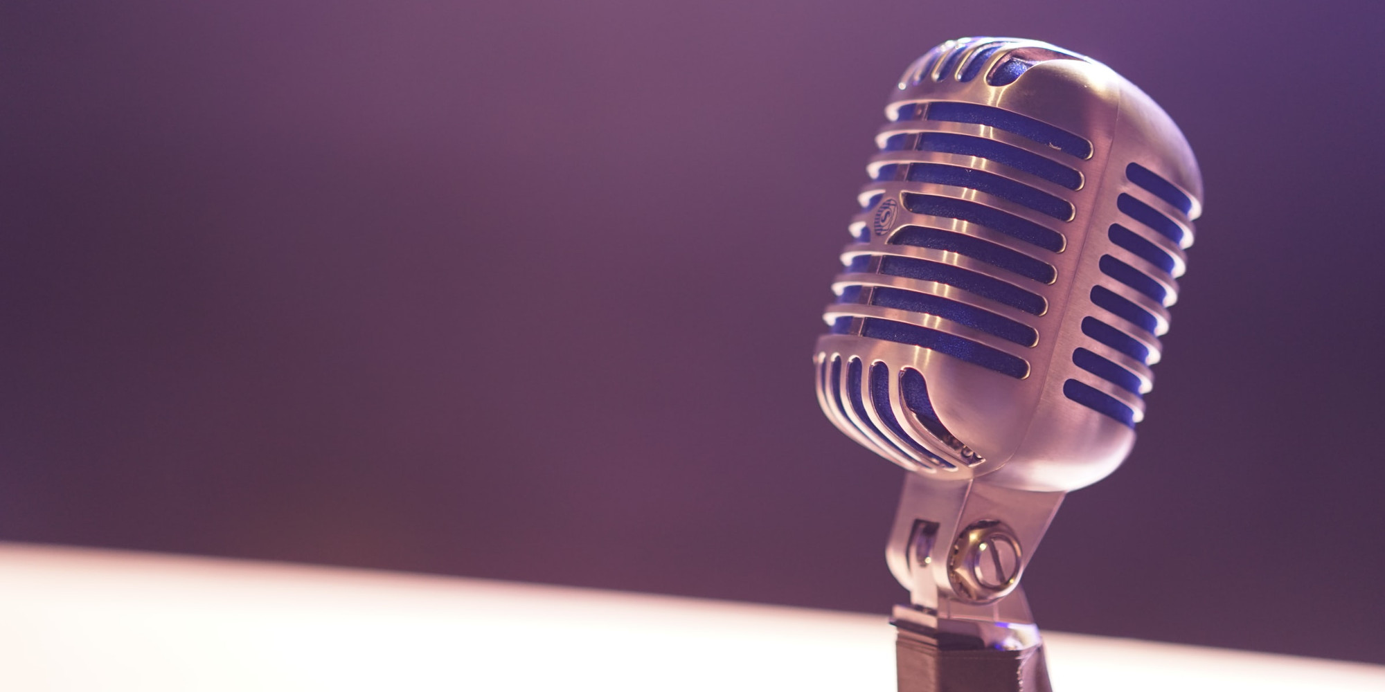 A microphone on a purple background